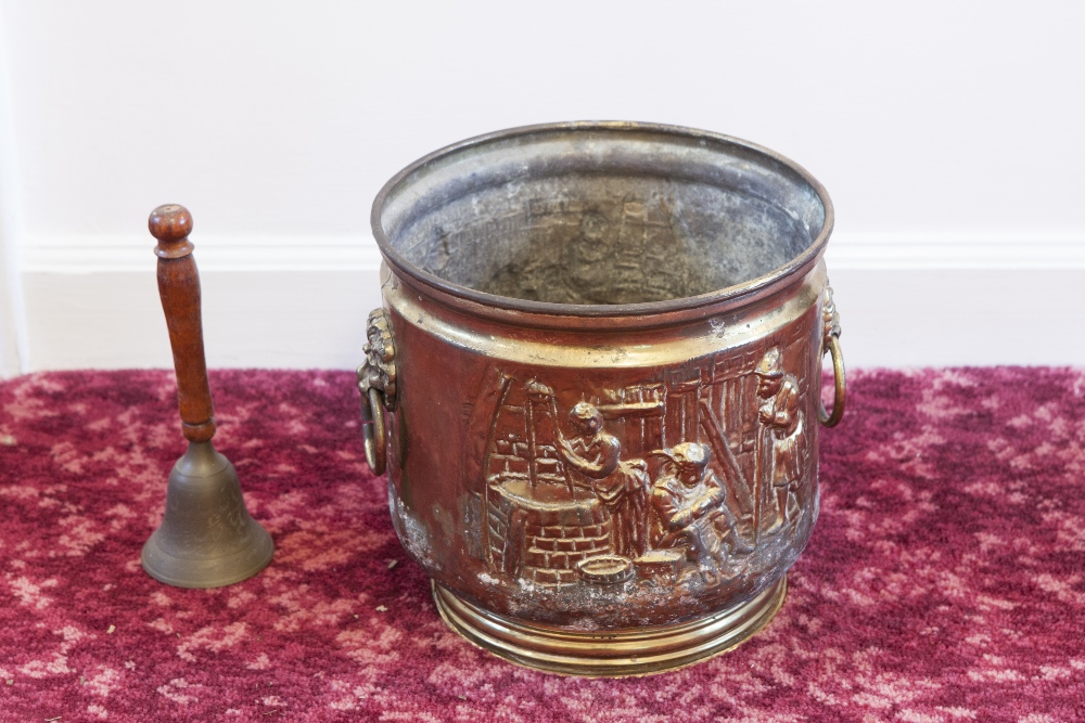 AN EMBOSSED BRASS TWO HANDLED CIRCULAR JARDINIÈRE AND A HANDBELL