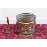 AN EMBOSSED BRASS TWO HANDLED CIRCULAR JARDINIÈRE AND A HANDBELL