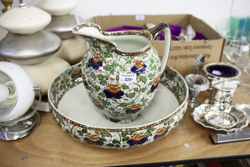 A LARGE ROYAL DOULTON WASH BASIN AND JUG WITH FLORAL DECORATION ON WHITE GROUND