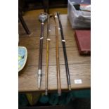 A SILVER TOPPED EBONY WALKING CANE, TWO OTHERS AND A SHOOTING STICK (4)