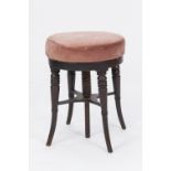 A GEORGE IV MAHOGANY HEIGHT ADJUSTABLE MUSIC STOOL on four turned and outset legs