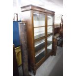 AN EARLY TWENTIETH CENTURY MAHOGANY LIBRARY BOOKCASE WITH TWO PLAIN GLAZED DOORS, ENCLOSING THREE