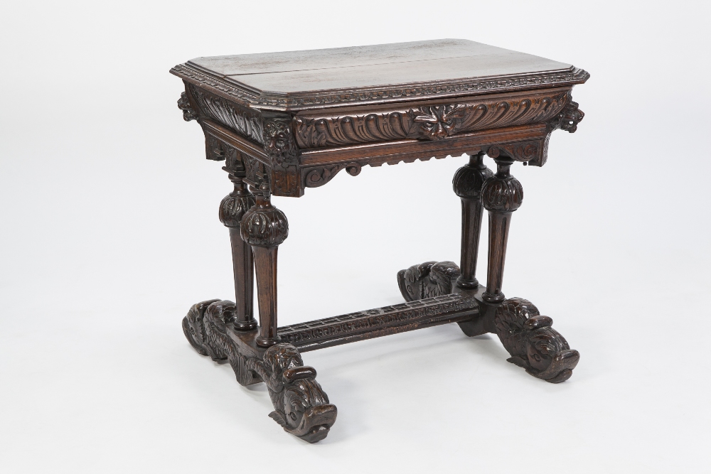 VICTORIAN CARVED OAK WRITING TABLE IN THE RENAISSANCE STYLE, the canted oblong top above a gadrooned