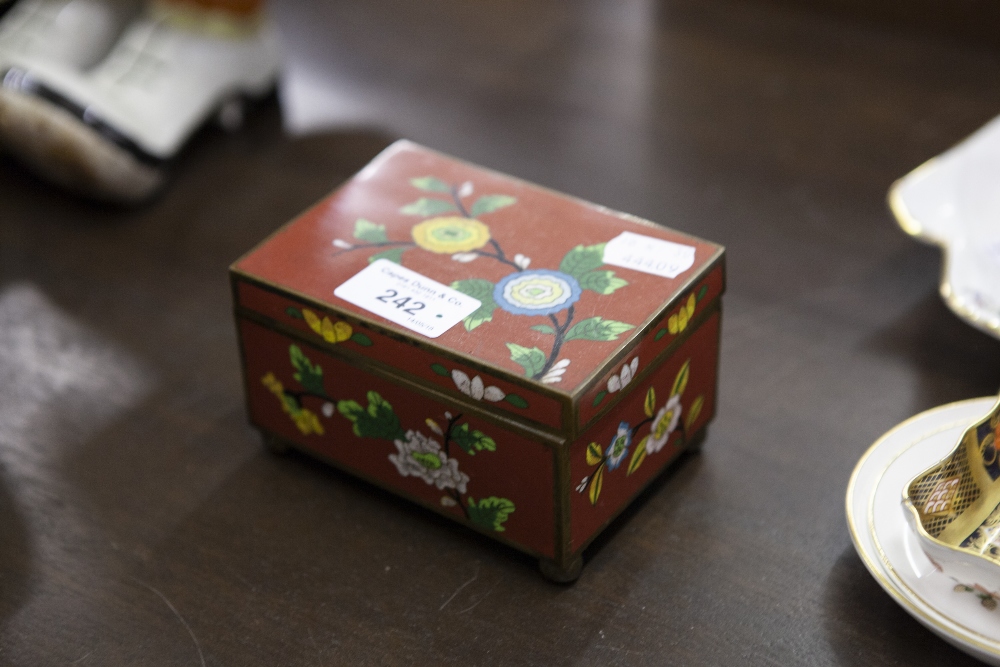 CHINOISERIE ENAMELLED SMALL OBLONG BOX AND HINGED COVER, FLORAL DESIGN AND AN IRON RED GROUND, 4 3/