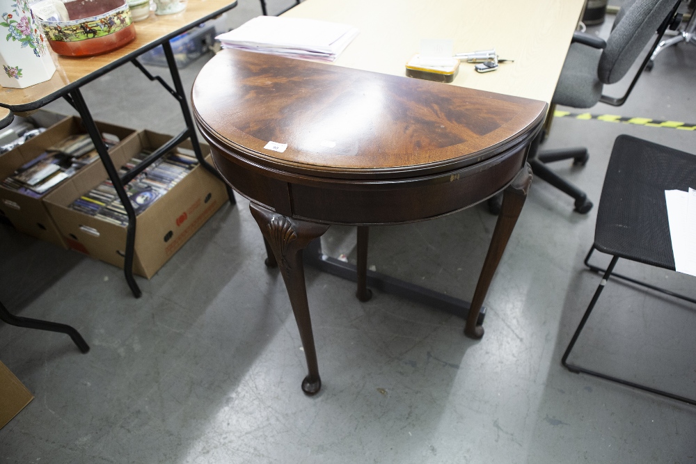 A REPRODUCTION MAHOGANY DEMI-LUNE CARD TABLE, ON CABRIOLE SUPPORTS