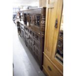 A LARGE OAK BUFFET CUPBOARD, THE TOP SECTION HAVING TWO LEADED GLAZED DOORS AND LOWER SECTION HAVING