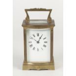 EARLY TWENTIETH CENTURY FRENCH GILT METAL SERPENTINE FRONTED CARRIAGE CLOCK IN FITTED MOROCCO