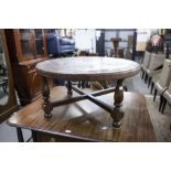 A ROUND COFFEE TABLE, 34 1/2" DIAMETER, WOOD COVERED IN LEATHER CARVED WITH INCAN MOTIFS, MADE IN