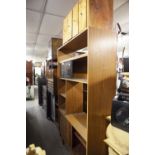 A 1960's TEA SIDE UNIT, OF OPEN SHELVES ON A CUPBOARD BASE AND A LOW BOOKCASE WITH GLASS SLIDING