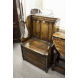 A TWENTIETH CENTURY REPRODUCTION SMALL OAK BOX SEAT