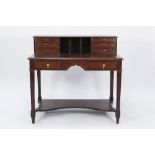 AN EARLY TWENTIETH CENTURY MAHOGANY WRITING DESK, with raised back having three central open