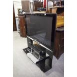 A PANASONIC VIERA FLAT SCREEN TELEVISION, 46" ON BLACK GLASS STAND AND A TOSHIBA DVD AND VIDEO