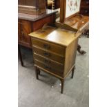 AN EARLY TWENTIETH CENTURY OAK MUSIC CABINET OF FOUR FALL FRONT DRAWERS