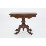 VICTORIAN CARVED ROSEWOOD PEDESTAL CARD TABLE, the moulded oblong, swivel top with circular claret