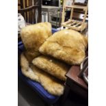 A NATURAL GREY SHEEPSKIN RUG AND A LIGHT BROWN SHEEPSKIN RUG, AND THREE FUR FABRIC CUSHIONS