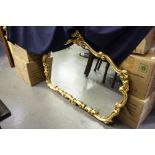 A LARGE CARTOUCHE SHAPED WALL MIRROR IN GILT ROCOCO FRAME, 4' WIDE, 3' HIGH OVERALL