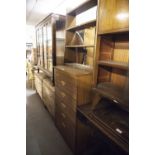 AN OAK DWARF OAK BOOKCASE AND A TEAK EFFECT CHEST OF FIVE DRAWERS