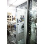 A GREY FINISH CORNER DISPLAY CABINET WITH TWO GLASS SLIDING DOORS, ENCLOSING FOUR GLASS SHELVES TO