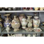 A PAIR OF EARLY TWENTIETH CENTURY JAPANESE EARTHENWARE VASES, ENAMELLED AND GILDED ON A LAVENDER