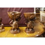 NATIVE CARVED BURRWOOD FIGURAL STOOL, THE STANDING FIGURE HOLDING ALOFT THE SEAT IN THE FORM OF A