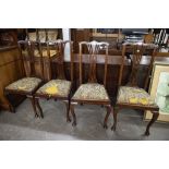 A SET OF FOUR DINING CHAIRS, WITH PIERCED BACK SPLAT AND DROP IN SEAT, RAISED ON CABRIOLE FORE LEGS