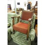 A SMALL OAK LOW SEATED ARMCHAIR