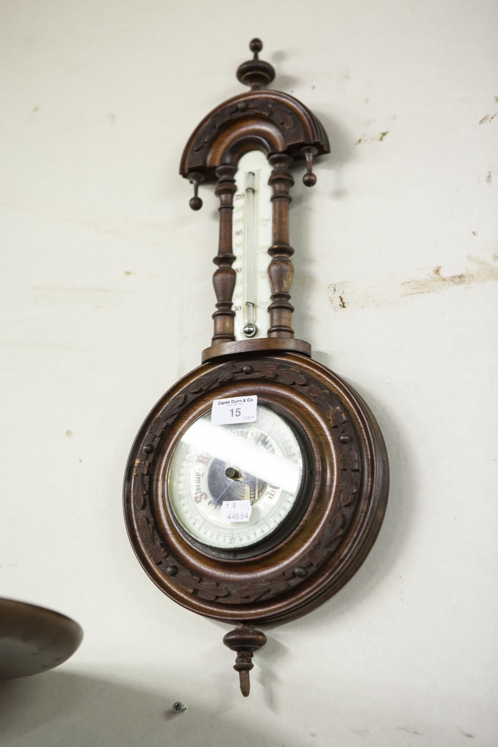 EDWARDIAN CARVED WALNUTWOOD BANJO SHAPED ANEROID BAROMETER, WITH REVEALED WORKS AND THERMOMETER