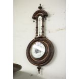 EDWARDIAN CARVED WALNUTWOOD BANJO SHAPED ANEROID BAROMETER, WITH REVEALED WORKS AND THERMOMETER