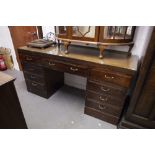 A TWENTIETH CENTURY MAHOGANY DOUBLE PEDESTAL DESK WITH NINE DRAWERS, ON PLINTH BASES, 5;6" X 1'8"