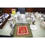 A SET OF TWELVE ORIENTAL EMBROIDERED TABLE MATS WITH SILK CENTRAL PANEL WITH FLORAL DECORATION, A