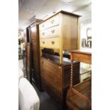 AN OAK CHEST OF FOUR DRAWERS WITH DROP HANDLES AND A SIMILAR CHEST OF THREE DRAWERS (2)