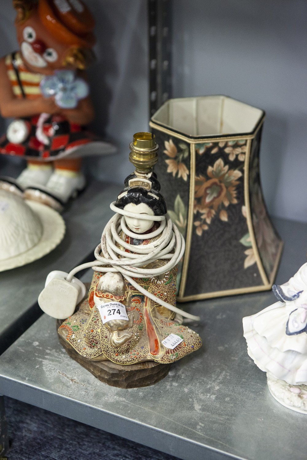 A JAPANESE TABLE LAMP, GEISHA GIRL SEATED WITH PUG IN ELABORATE GILT GOWN WITH COLOUR HIGHLIGHTS, ON