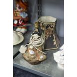 A JAPANESE TABLE LAMP, GEISHA GIRL SEATED WITH PUG IN ELABORATE GILT GOWN WITH COLOUR HIGHLIGHTS, ON