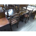 AN EDWARDIAN OAK GATELEG TABLE AND FIVE CHAIRS (4 + 1)