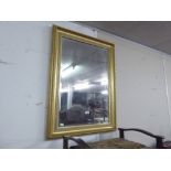 A GILT FAMED OBLONG WALL MIRROR