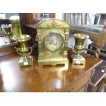 A VICTORIAN BRASS CLOCK GARNITURE, THE MANTEL CLOCK WITH ARCHED TOP, PILASTER SIDE COLUMNS, BLACK