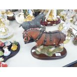 A BRONZE EFFECT RESIN MODEL OF A CLASSICAL HORSE, ON OBLONG BASE AND A BLACK WOOD PLINTH AND A RESIN