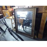 AN OBLONG GILT FRAMED WALL MIRROR