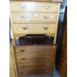 AN OAK CHEST OF FOUR DRAWERS WITH DROP HANDLES AND A SIMILAR CHEST OF THREE DRAWERS (2)