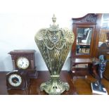 A VICTORIAN PIERCED BRASS FIRE-SCREEN, THE FAN FOLDING AWAY TO THE CENTRAL COLUMN, WITH CLASSICAL