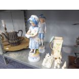 A PAIR OF VICTORIAN FIGURINES OF A BOY AND GIRL, ON BASES (2)