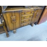 EDWARDIAN OAK SIDEBOARD HAVING FOUR CENTRAL DRAWER CUPBOARD TO EITHER SIDE, ALL RAISED ON CARVED CUP