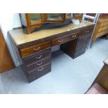 A TWENTIETH CENTURY MAHOGANY DOUBLE PEDESTAL DESK WITH NINE DRAWERS, ON PLINTH BASES, 5;6" X 1'8"