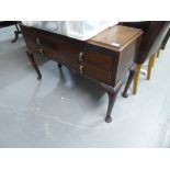 CIRCA 1920's CARVED MAHOGANY LOW CHEST OF FOUR DRAWERS, RAISED ON TALL CABRIOLE LEGS