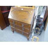 A REPRODUCTION MAHOGANY BUREAU, FALL FRONT OVER THREE GRADUATED DRAWERS, ON CABRIOLE SUPPORTS