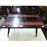 KOREAN BLACK LACQUERED AND RED TABLE, WITH COPPER INLAY ON FOLDING LEGS