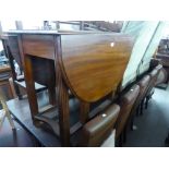 MAHOGANY DROP-LEAF DINING TABLE, AN OAK TEA TROLLEY; ANOTHER TEA TROLLEY