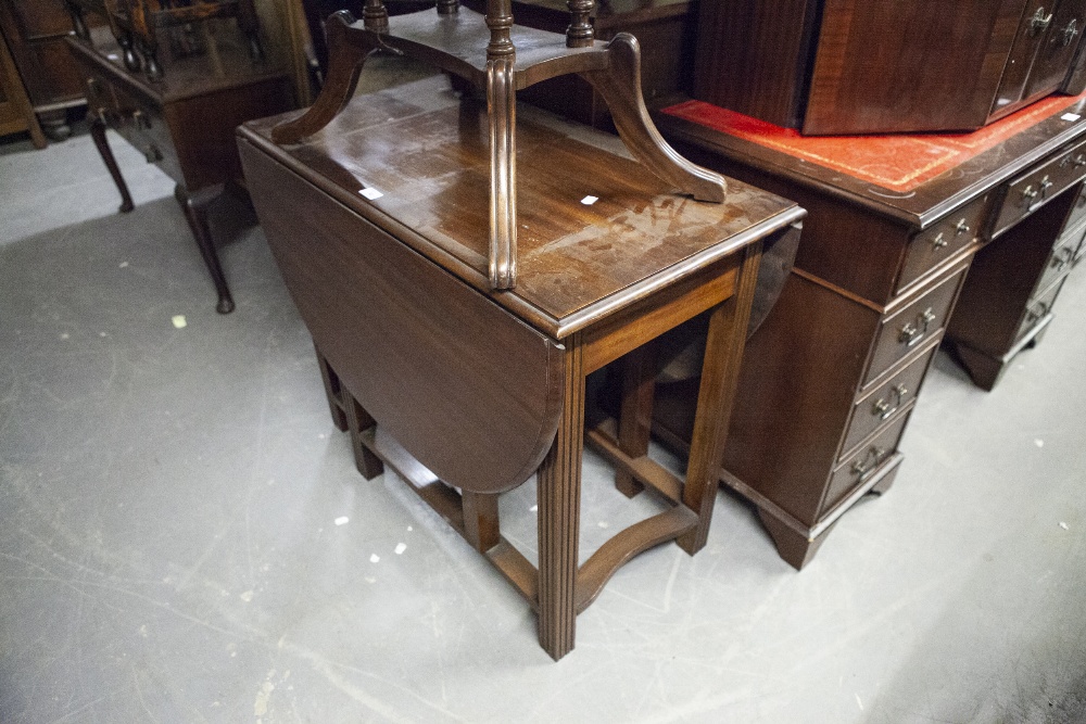 MAHOGANY DROP-LEAF DINING TABLE, AN OAK TEA TROLLEY; ANOTHER TEA TROLLEY