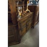 A CARVED OAK WELSH DRESSER WITH RAISED PLATE RACK