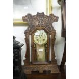 A LATE NINETEENTH CENTURY AMERICAN GINGERBREAD CLOCK, SHOWING TWO LIONS HEADS, MADE BY THE NEW HAVEN